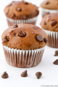 Close-up side view of Double Chocolate Muffins on a white background.