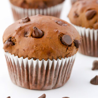 Close-up side view of Double Chocolate Muffins on a white background.