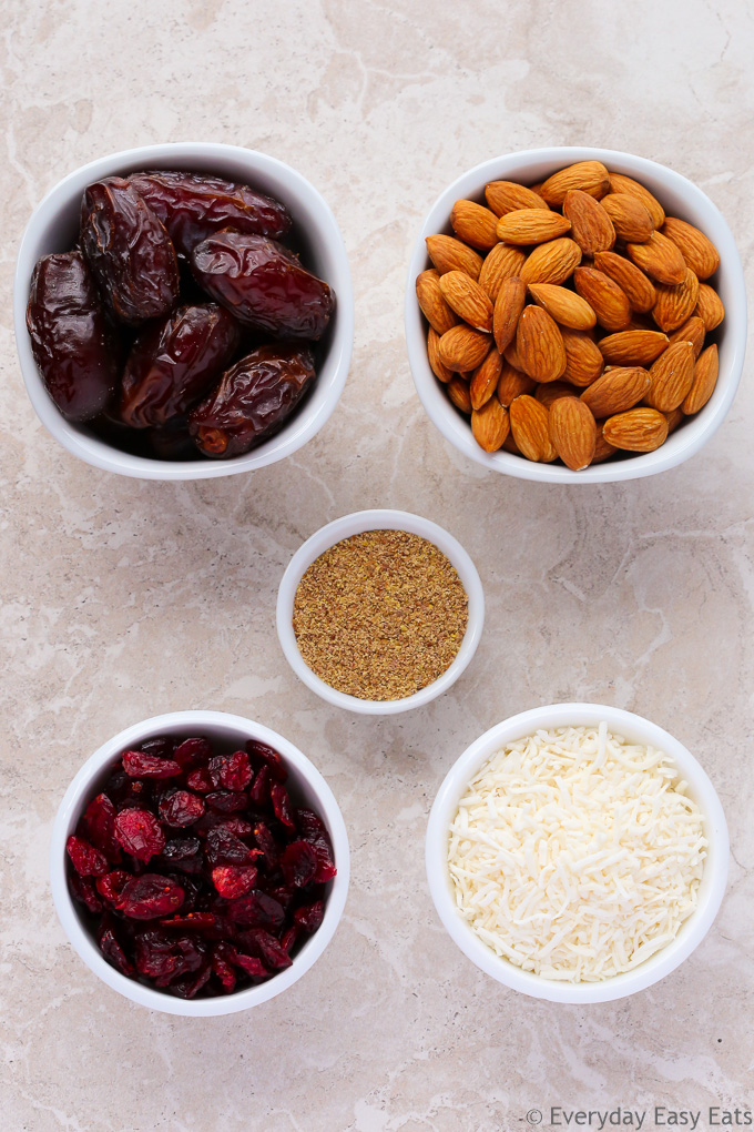 Overhead view of ingredients for Cranberry Coconut Energy Balls on a neutral background.