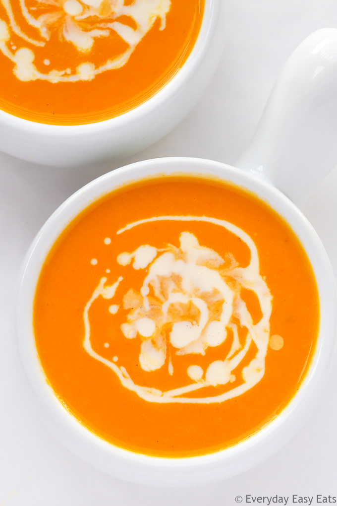 Overhead view of Creamy Carrot Ginger Soup on a white background.