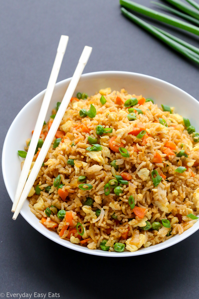 Overhead view of Chinese Fried Rice in a white plate on a dark background.