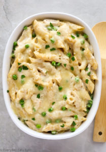 Overhead view of Chicken Alfredo Bake with Jar Sauce in a large white serving dish on a grey background.