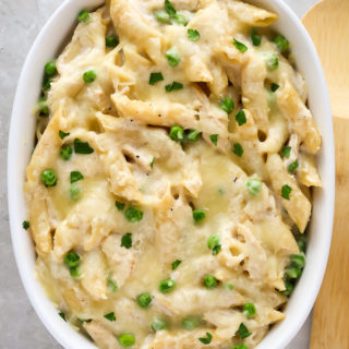 Overhead view of Chicken Alfredo Bake with Jar Sauce in a large white serving dish on a grey background.