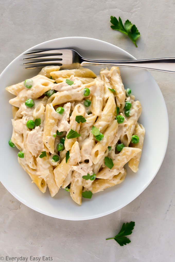 Overhead view of a plate of Chicken Alfredo with Jar Sauce on a grey background. 