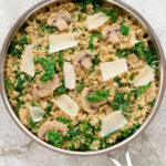 Overhead view of Mushroom Quinoa in a skillet on a neutral background.