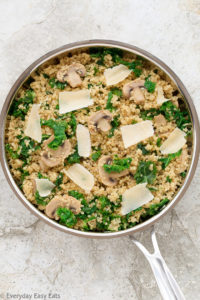 Overhead view of Mushroom Quinoa in a skillet on a neutral background.