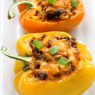 Close-up side view of Mexican Stuffed Peppers in a white serving dish.