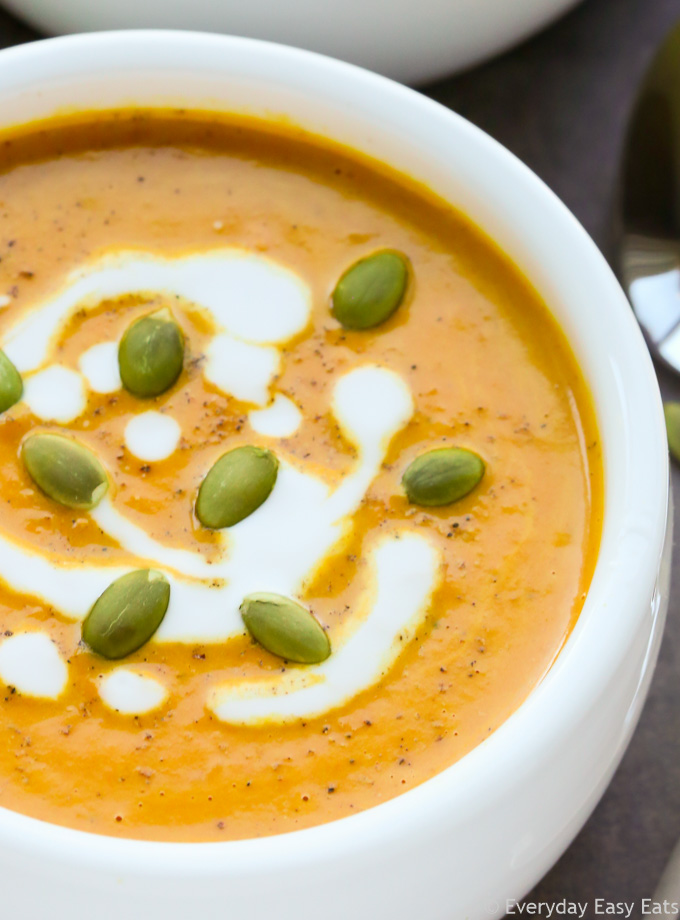 Close-up view of Curried Coconut Pumpkin Soup in a white bowl.