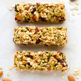 Overhead view of three No-Bake Healthy Fruit and Nut Granola Bars on a wooden background.