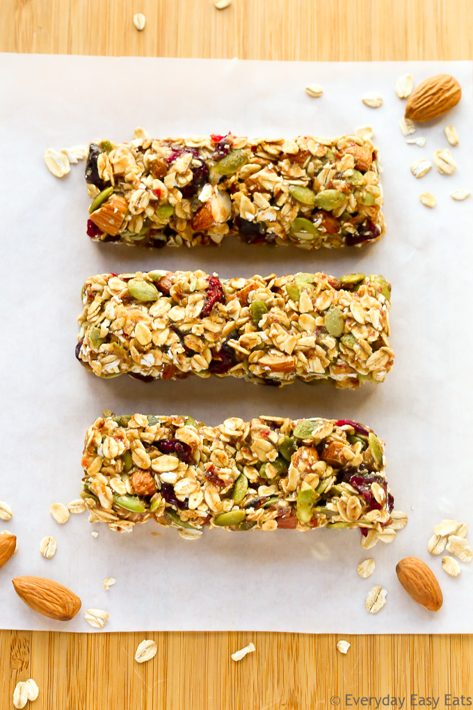 Overhead view of three No-Bake Healthy Fruit and Nut Granola Bars on a wooden background.