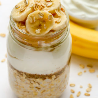 Overhead view of Peanut Butter Banana Overnight Oats in a mason jar against a white background.