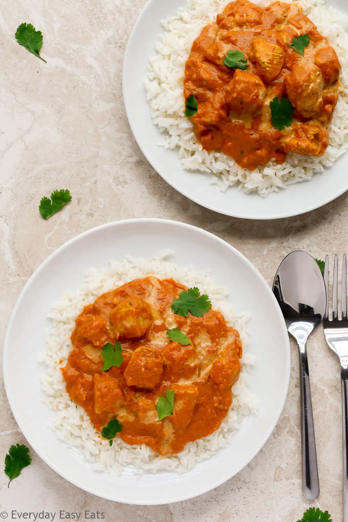 Overhead view of two plates of Quick Indian Chicken Curry over white rice.