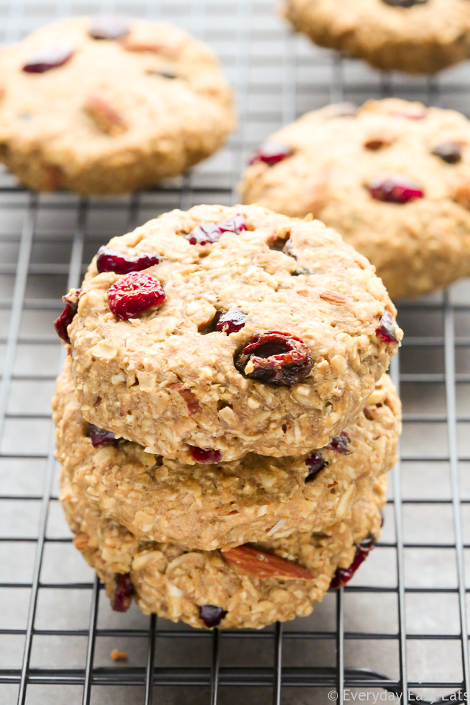 Side view of Peanut Butter Banana Oatmeal Cookies in a stack on a wire cooling rack set on a dark background.