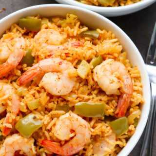 Close-up overhead view of a bowl of Cajun Shrimp and Rice on a dark background.