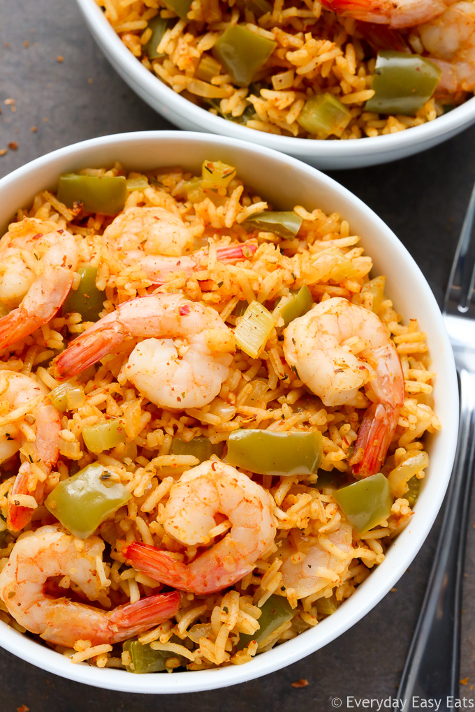 Close-up overhead view of a bowl of One-Pot Cajun Shrimp and Rice on a dark background.