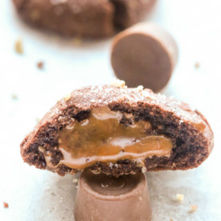 Close-up side view of half a Chocolate Rolo-Stuffed Cookie to show caramel inside.