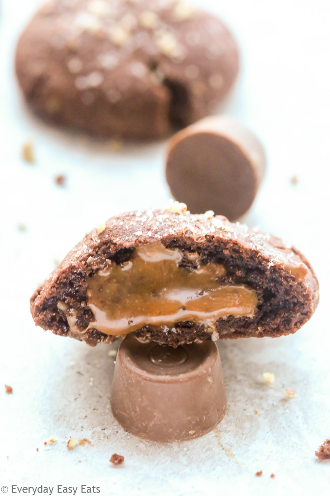 Close-up side view of half a Chocolate Rolo Cookies to show rolo stuffed inside.