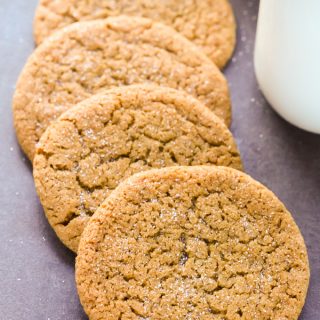 Close-up overhead view of Ginger Molasses Cookies Without Brown Sugar on a dark background.