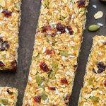 Close-up overhead view of No-Bake Healthy Nut-Free Granola Bars on a dark background.