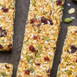 Close-up overhead view of No-Bake Healthy Nut-Free Granola Bars on a dark background.