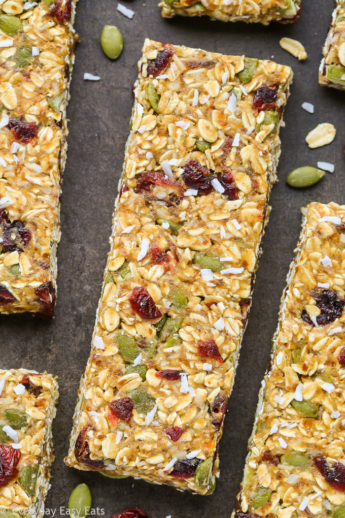 Close-up overhead view of No-Bake Healthy Nut-Free Granola Bars on a dark background.