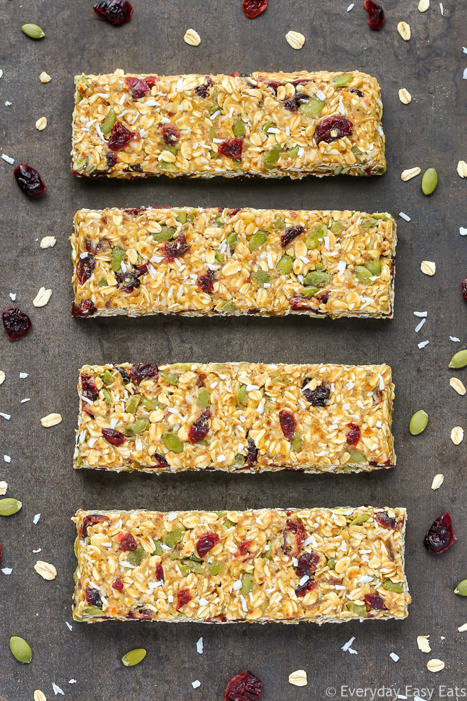 Overhead view of four No-Bake Healthy Nut-Free Granola Bars on a dark background.