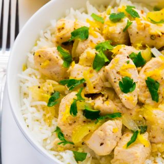 Close-up overhead view of Chicken Scampi Without Wine in a white bowl on a white background.