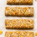 Overhead view of Healthy Mango Coconut Granola Bars on a neutral background.