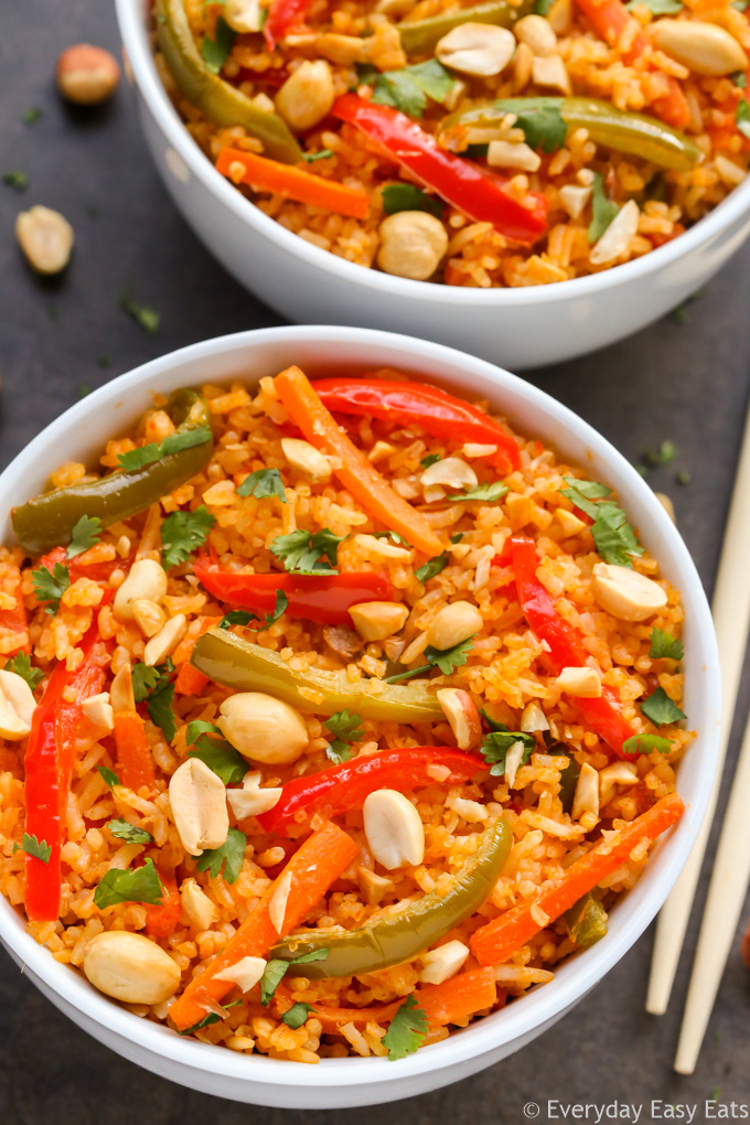 Close-up overhead view of Thai Red Curry Rice in a white bowl with chopsticks.