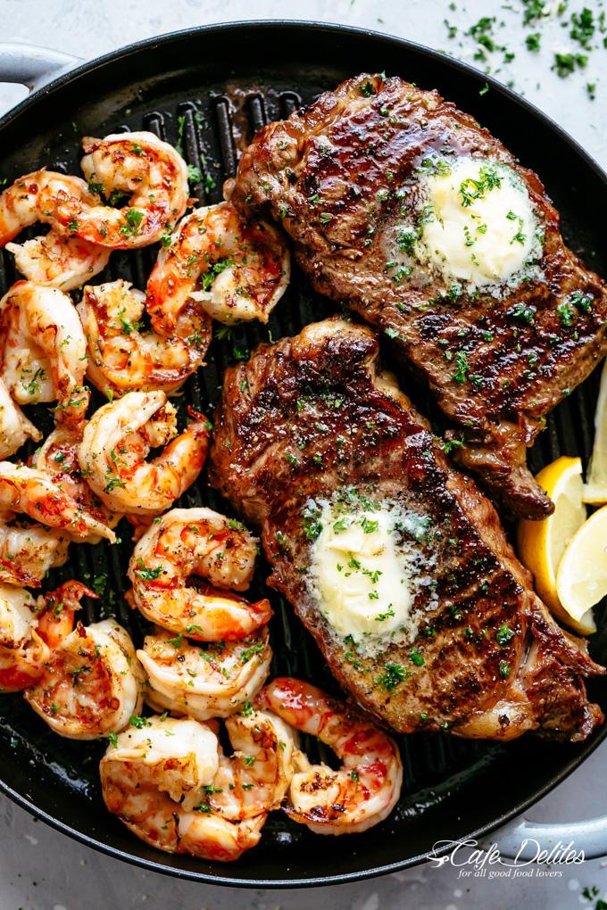 Healthy Grilled Meat Recipes for Summer: Overhead view of Garlic Butter Grilled Steak & Shrimp in a grill pan.
