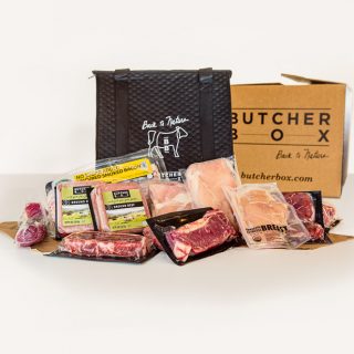 ButcherBox Review: Side view of ButcherBox with packages of grass-fed, organic meat on white background.