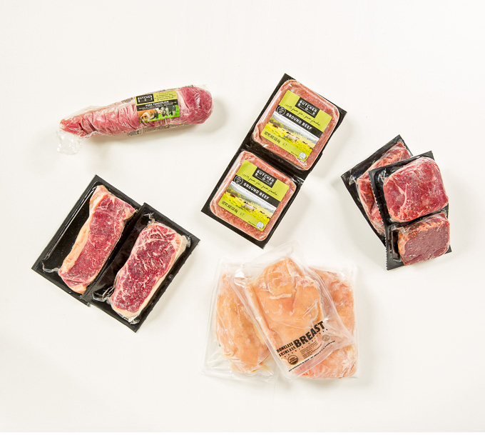 ButcherBox Review: Overhead view of packages of grass-fed, organic meat on white background