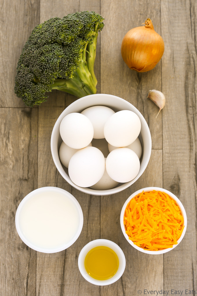 Overhead view of Broccoli Cheese Frittata ingredients on a wooden background.