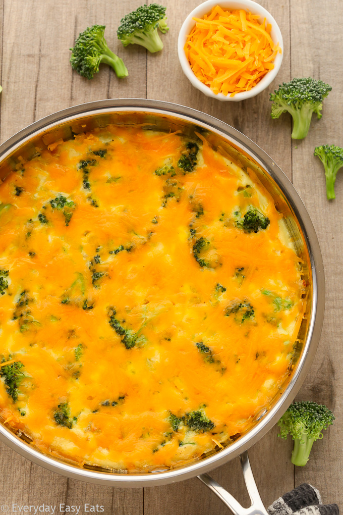 Close-up overhead view of Broccoli Cheese Frittata in a skillet on a wooden background.