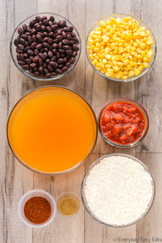 Overhead view of Vegetarian Burrito Bowl ingredients on a wooden background.