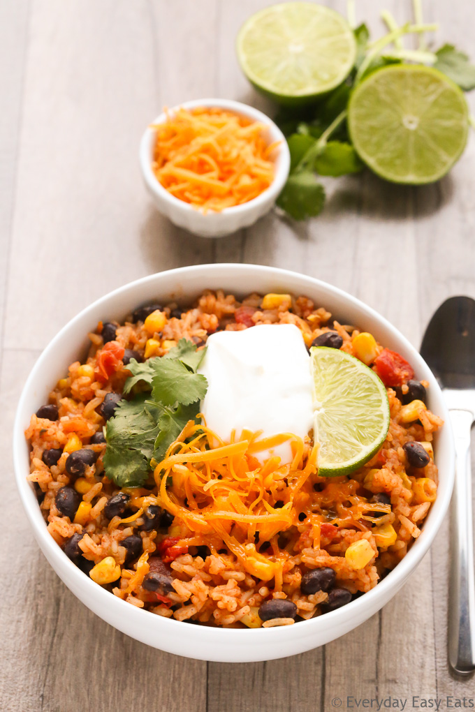 Overhead view of Burrito Rice in a white bowl on a wooden background.