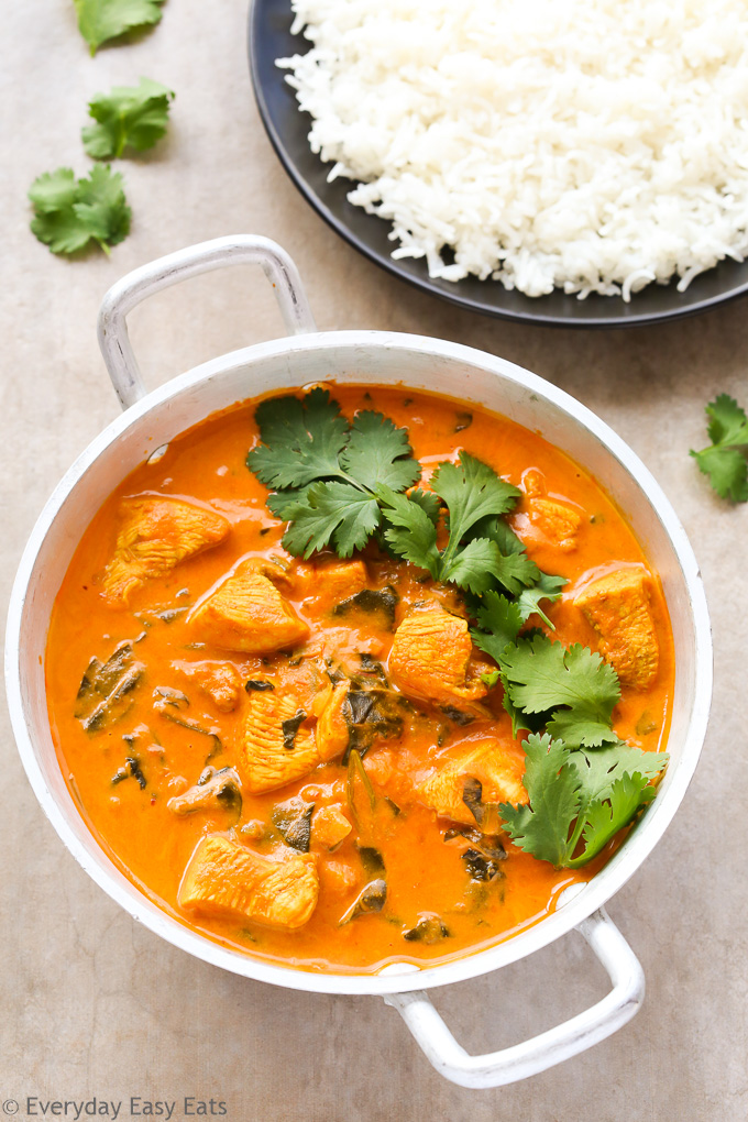 Overhead view of Indian Coconut Chicken Curry in a silver serving dish.