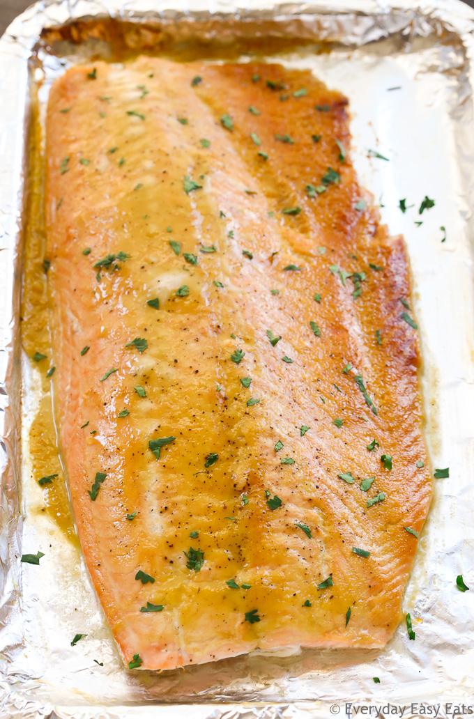 Overhead view of Baked Honey Mustard Salmon on a foil-lined baking sheet after being baked in the oven.