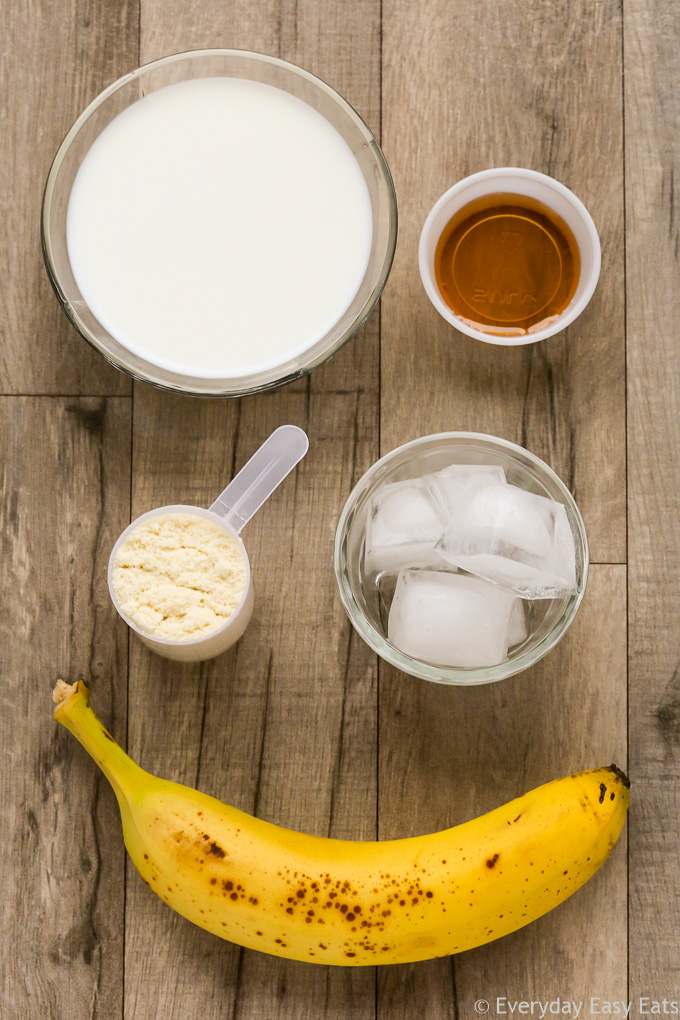 Overhead view of ingredients required to make a Vegan Protein Shake on a wooden background.