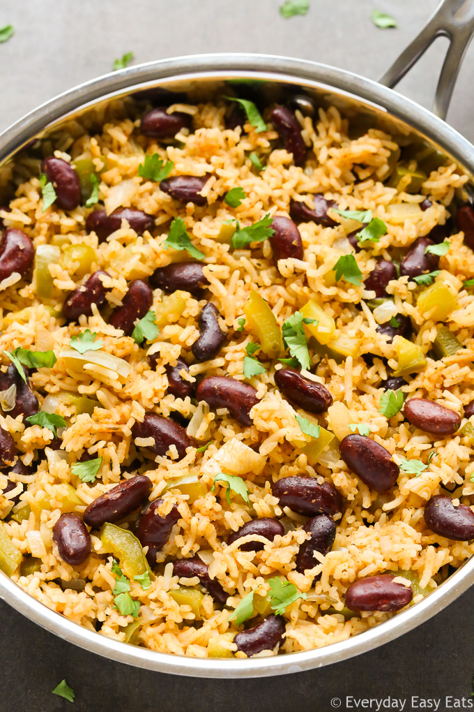 Close-up overhead view of Vegetarian Dirty Rice in a silver skillet on a dark surface.