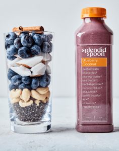 Side view of smoothie ingredients and a bottled smoothie.