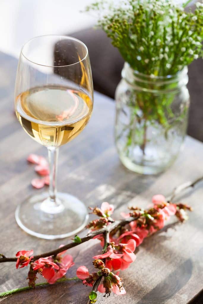 Organic and Natural Wine Delivery: Glass of white wine with flowers on the side