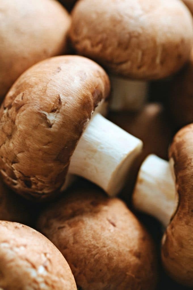 Close-up view of whole fresh brown mushrooms.